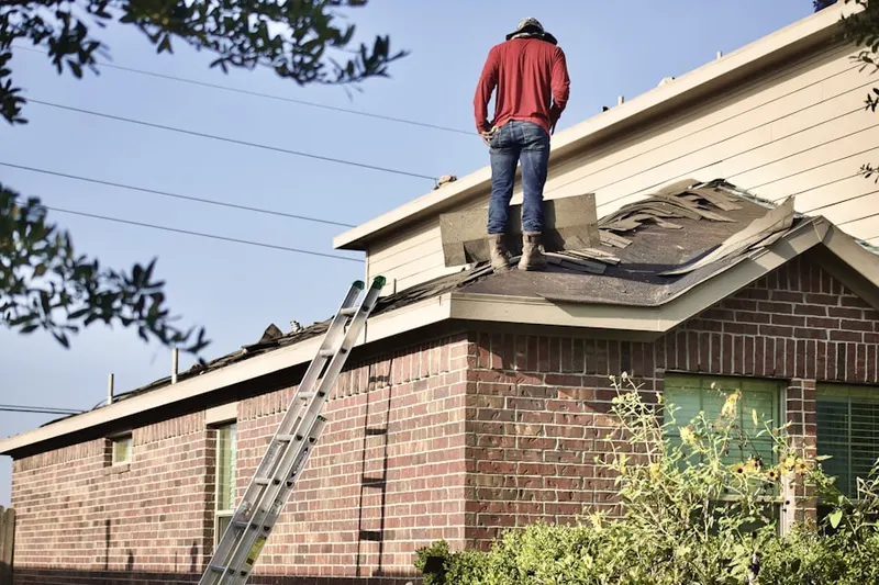 Professional roofer working on a residential roof in Edicks